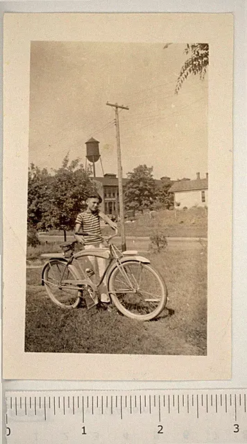 1941 Photo Cute 10 Year Old Boy Bicycle Water Tower Buildings School?